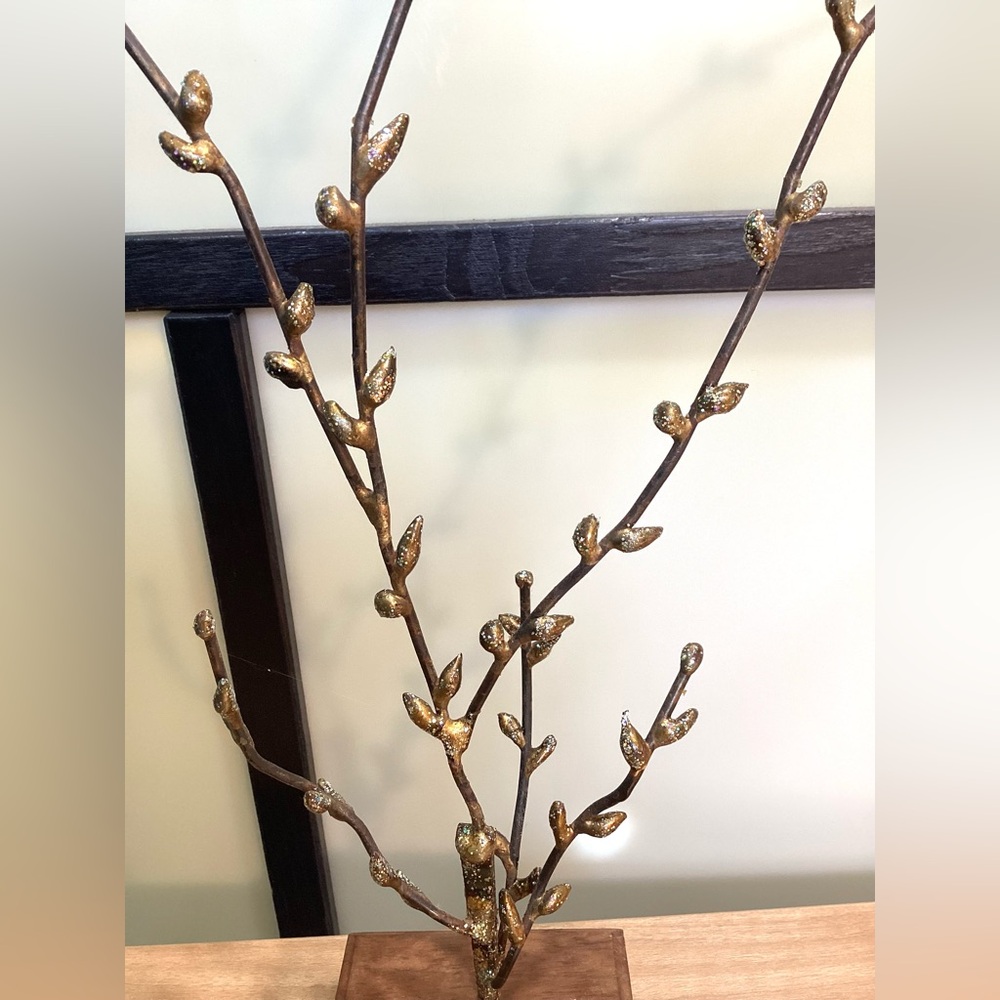 Decorative metal branches with gold color leaves.